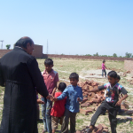 Fr. John greeting children